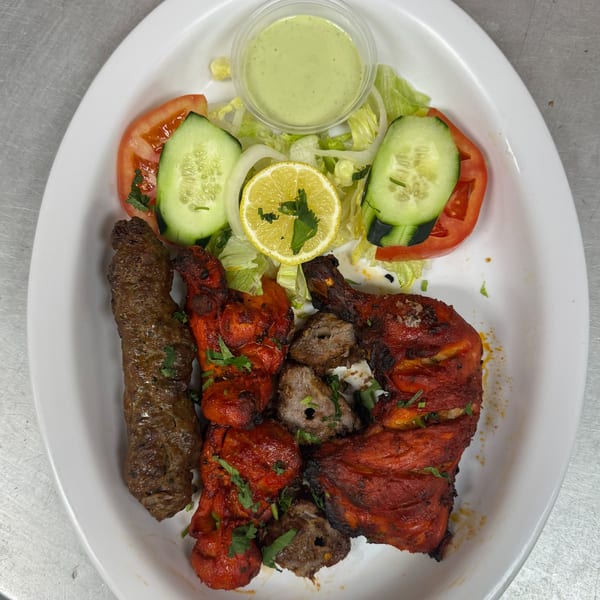 Chaat House mixed grill platter with seekh kebab, chicken tikka, lamb boti, and salad.